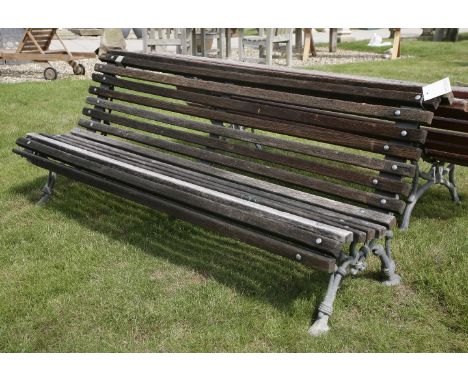 A cast iron park bench, with slatted back and seat, 200cm long