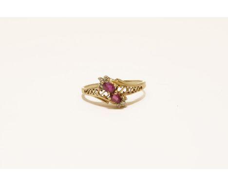 A gold ruby and diamond crossover ring, size P, marked 14 (tested as 14ct)2.24g