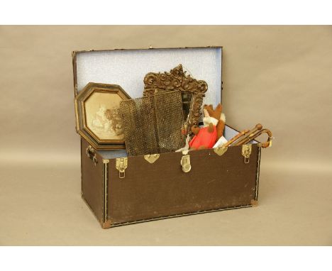 A trunk and contents, including: mirror, pictures, leather letter case, iron horse ornament, fire tools, walking sticks, musi
