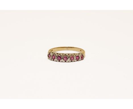 A 9ct gold seven stone ruby half hoop ring, size N1.68g