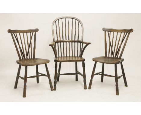 A 19th century elm and beech Windsor elbow chair, with hoop stick back above solid seat on stretched support and a  pair of s