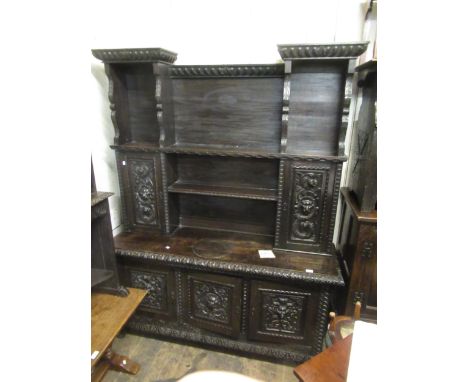 19th Century carved oak dresser, the boarded shelf and cupboard back above a three door base on low cabriole supports, the wh