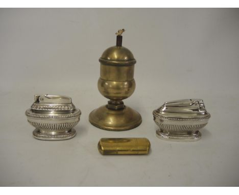 Heavy bronze table lighter, two silver plated table lighters and a brass cased lighter 