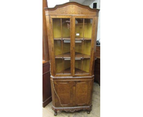 Good quality mid 20th Century figured walnut standing corner cabinet with two bar glazed doors enclosing shelves, above two p
