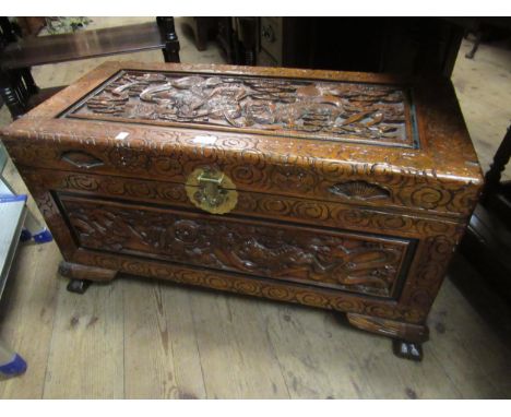 Chinese trunk, the cover carved with dogs of foe, 85 x 40 x 49cm high 
