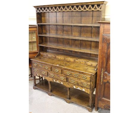 Good quality reproduction oak dresser, the boarded shelf back with six small drawers, the base with a moulded top above an ar