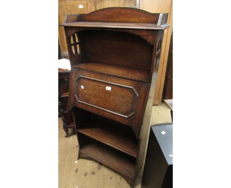 Late Victorian carved oak bureau cabinet with an open shelf above a fall front, the base with further open shelf space, 150 x