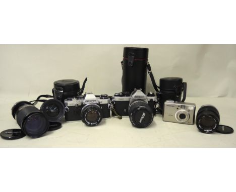 Box containing a collection of various cameras including a Nikon FM2 SLR camera with lens, an Olympus SLR camera, Tamron lens