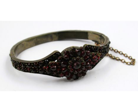 Continental white metal and garnet set bangle (at fault) 