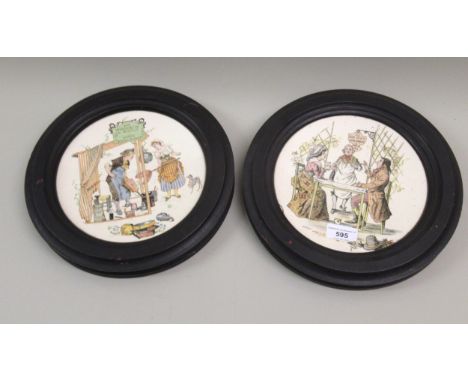 Pair of 19th Century French Sarreguemines plates with printed decoration of figures in ebonised wooden frames, 19cm diameter 