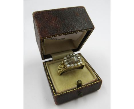 19th Century gold memorial ring with hairwork panel surrounded by seed pearls, inscribed ' Jack ' (with resizing marks), size