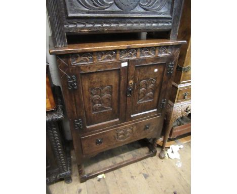 Good quality reproduction oak side cabinet with two carved recessed panel doors above a single drawer on barley twist support