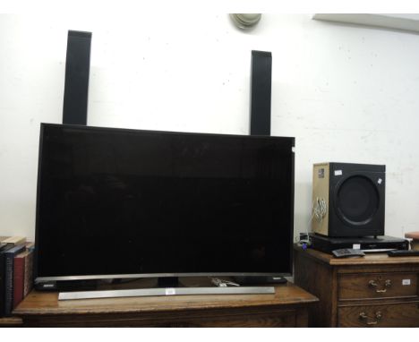 Samsung UHD curved panel TV and a Panasonic DVD player with surround sound 