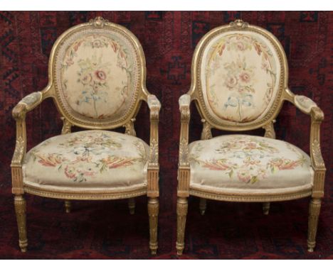 FAUTEUILS, a pair, late 19th century French with a giltwood showframe and Aubusson tapestry covers on fluted turned legs, 95c