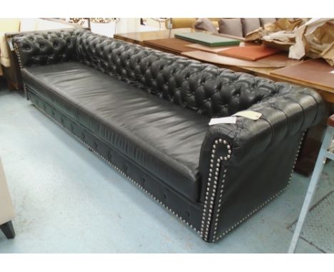 CHESTERFIELD STYLE SOFA, black leather with studded metal detail, on bun feet, 280cm x 90cm x 75cm.