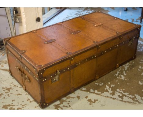 STEAMER TRUNK, brass studded tan leather with side handles, 39cm H x 122cm W x 61cm D.