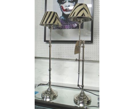 TABLE LAMPS, a pair, extendable in chromed metal with shades, 79cm H. (2)