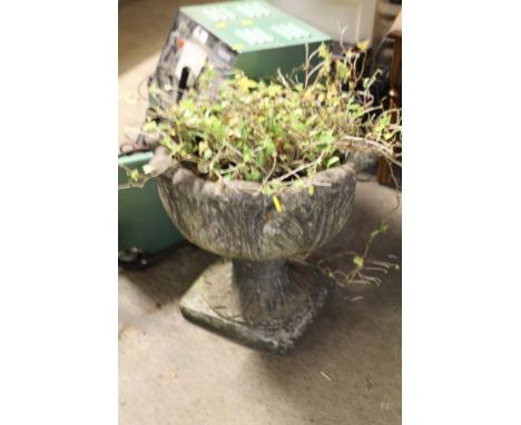 A SMALL GARDEN STONE PLANTER 