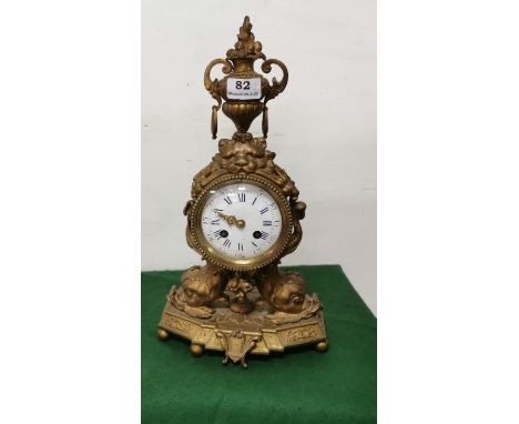 Ormolu Gilt framed Mantle Clock, late 19thC, with an ornate classical finial in the form of an urn over a white face with blu