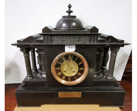 Mantel Clock with 4 doric columns and a black face with gold numerals, also a brass presentation label dated 1907, 45cm x 48c