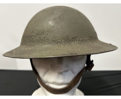 WW1 US M1917 Steel Helmet. Three holes have been drilled to each side of the rim to allow fitment of a steel face sheild. Hea