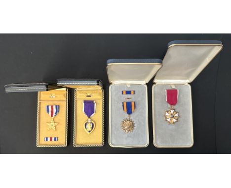 Collection of four United States Medals in presentation cases to include: Purple Heart complete with enamel lapel pin, unissu
