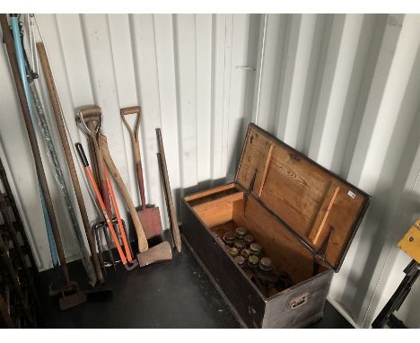 Selection gardening tools and quantity of brass horse cart hub caps and spanners in a wooden trunk 
