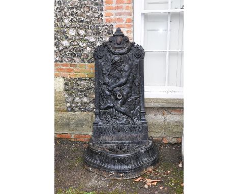 
	
		A painted cast iron wall fountain to a model by Val d'Osne, late 19th century, the shaped rectangular backplate with arc