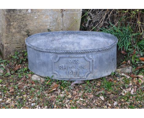 
	
		An English lead planter, late 20th century, of shaped oval form, with rope twist rim and central cartouche cast with ins