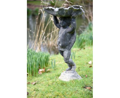 
	
		A lead figural bird bath, possibly H. Crowther, 20th century, modelled with a standing putto raising a scallop shell bas