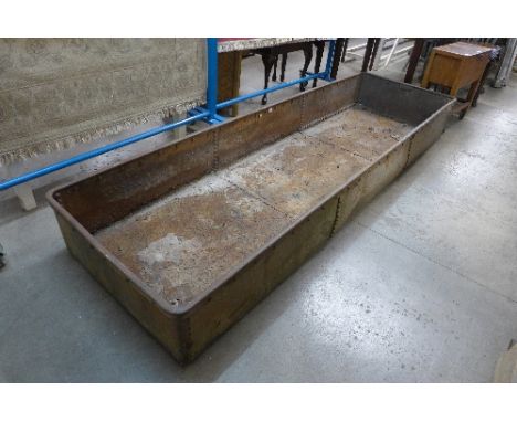 A large industrial cast iron trough