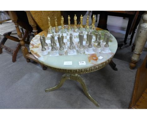 A brass and onyx games table with chess set