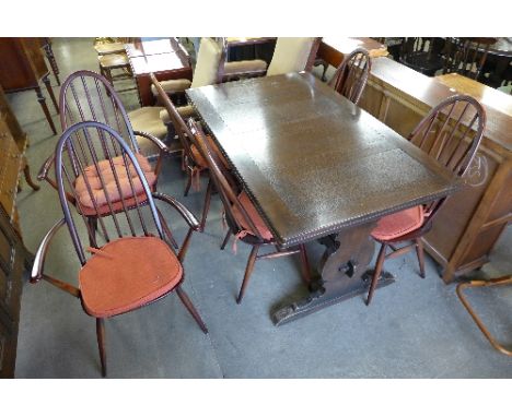 An Ercol oak refectory draw-leaf table and six Ercol chairs