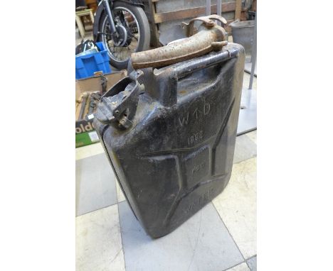 A box of tools including a vintage tape measure and a jerry can dated 1952