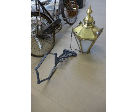 A brass pub lantern and bracket