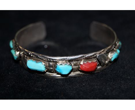 White metal (possibly Indian silver) bangle set with 7 hard stones.
