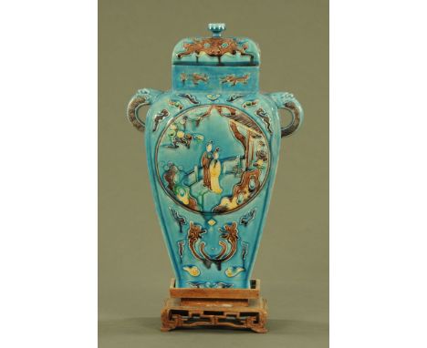 A Chinese archaic vase and cover on a wooden stand.  Six character mark to base.  Height excluding stand 31 cm. CONDITION REP