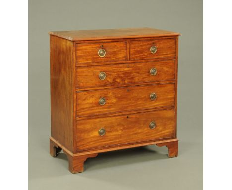 A George III mahogany chest of drawers, with moulded edge above two short and three long graduated drawers with brass drop ha