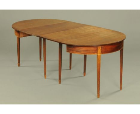 A 19th century mahogany dining table, comprising two D ends, each with drop leaf and raised on eight tapered legs of square s