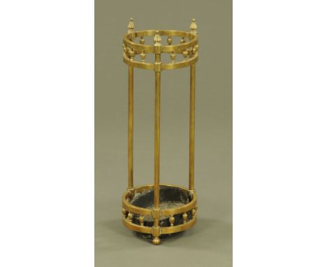 An Edwardian circular brass hall stick stand, with later drip tray.  Height 65 cm, diameter 23 cm.
