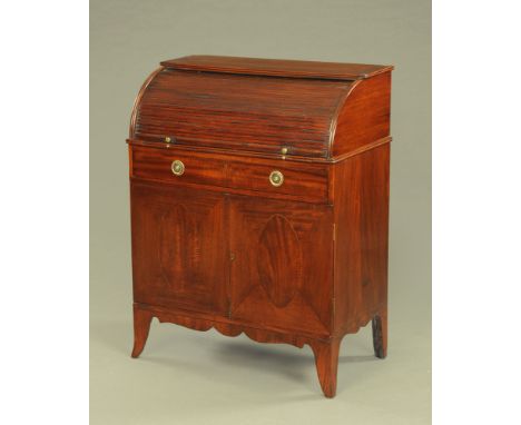 A 19th century mahogany cylinder bureau, with tambour front and pullout slide with drawer above a pair of panelled cupboard d