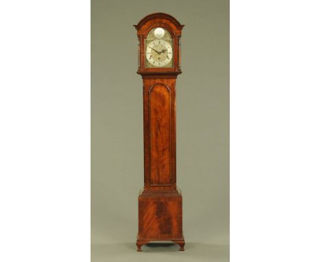 A mahogany grandmother clock, with silvered brass arched dial with three train striking movement flanked by turned columns wi