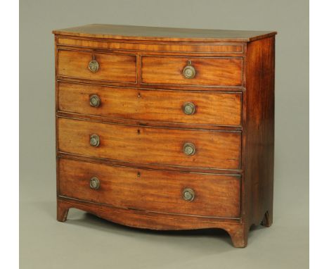 An early 19th century mahogany crossbanded chest of drawers, with two short over three long drawers with brass drop handles w