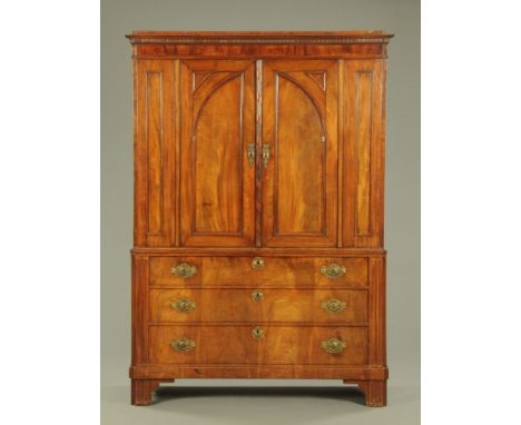 A 19th century continental linen press, with moulded dentil cornice above a crossbanded frieze and a pair of panelled doors o