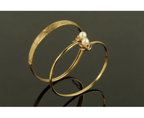 Two 9 ct gold bangles, one with pearl terminals, 10.8 grams gross.