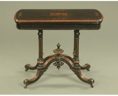 A Victorian aesthetic movement ebonised card table, with rounded ends the turnover top with brown baize lined interior and ra