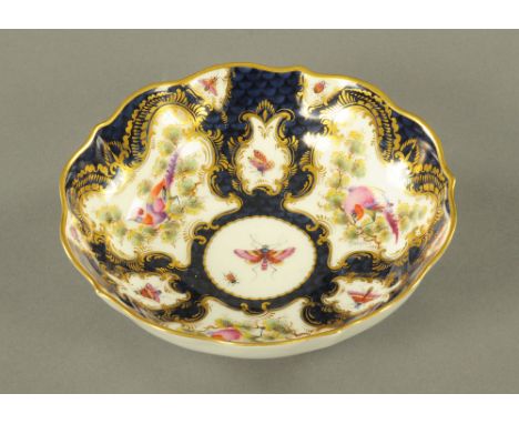 A Royal Worcester bird and butterfly patterned dish, heightened with gilding and with blue printed mark to base.  Diameter 15