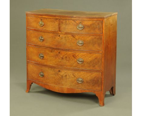A George IV figured mahogany bow front chest of drawers, fitted two short and three long drawers on splayed feet.  103 cm hig