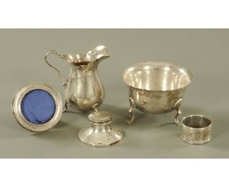 A George V silver two piece part tea service, with shaped rims on splayed feet, comprising cream jug and sugar basin.  Combin