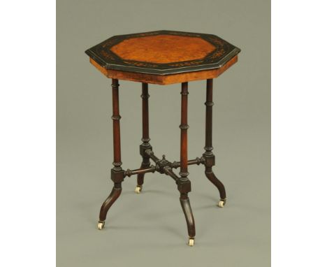 A Victorian aesthetic period walnut inlaid octagonal table, with moulded edge turned supports turned stretchers and outswept 